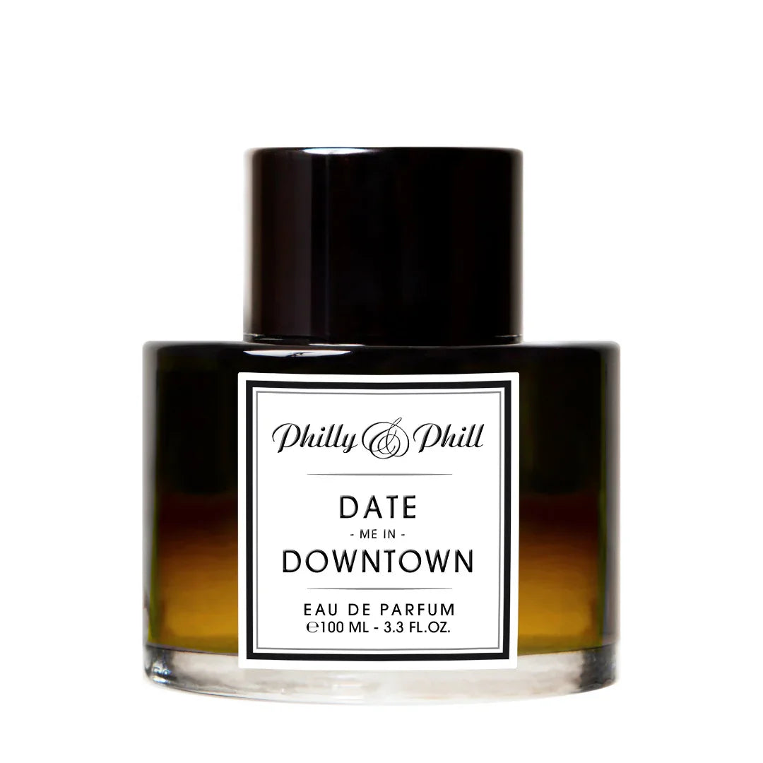 Flakon "DATE ME IN DOWNTOWN" von Philly & Phill, schwarz-goldenes Design mit weißem Etikett und schwarzem Deckel.