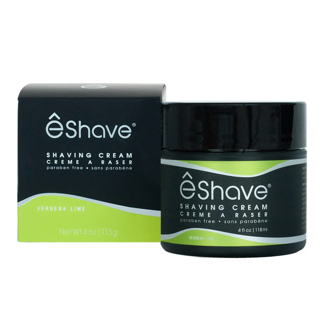 Rasiercreme in einem schwarzen Tiegel mit grünen Etikett, neben einer passenden schwarzen Verpackung. Produkt: Shaving Cream Verbena Lime, Anbieter: eShave.