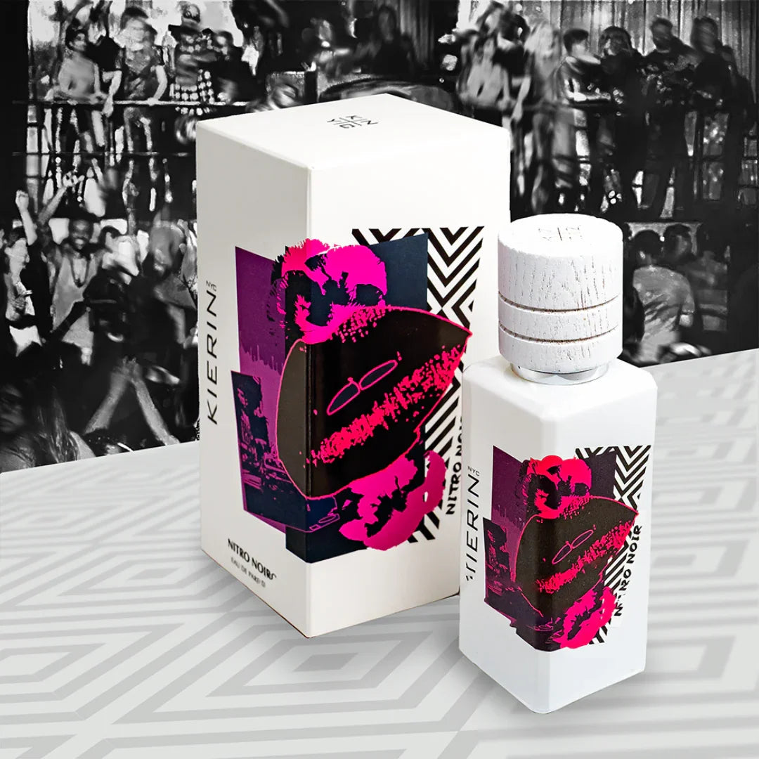Parfümflasche und Karton von "Nitro Noir" der Marke "Kierin NYC", beide mit lebhaften rosa und schwarzen Grafiken.