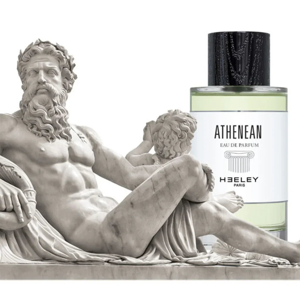 Das Produkt "Athenean" von "Heeley" zeigt eine Flasche Eau de Parfum neben einer klassischen Skulptur eines liegenden Mannes.