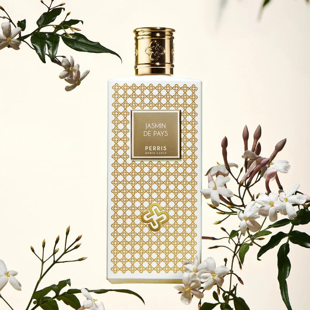 Perris Monte Carlo "+Jasmin de Pays+" Eau de Parfum Flakon mit goldfarbenem Muster, umgeben von Jasminblüten.