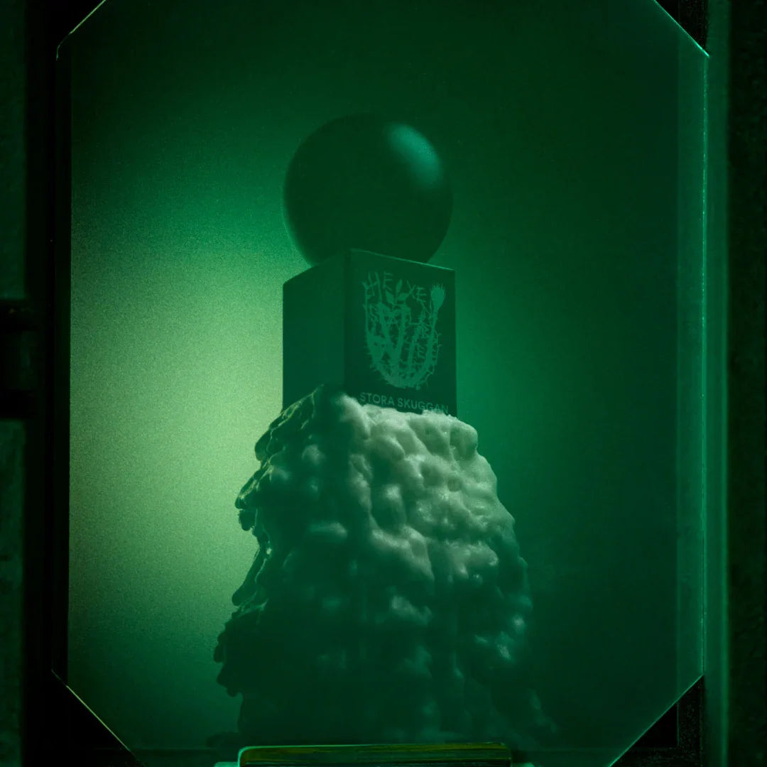 Ein Flakon "Hexensalbe" von Stora Skuggan. Schwarzer rechteckiger Flakon mit runder Kappe und wachsartiger Textur unten.