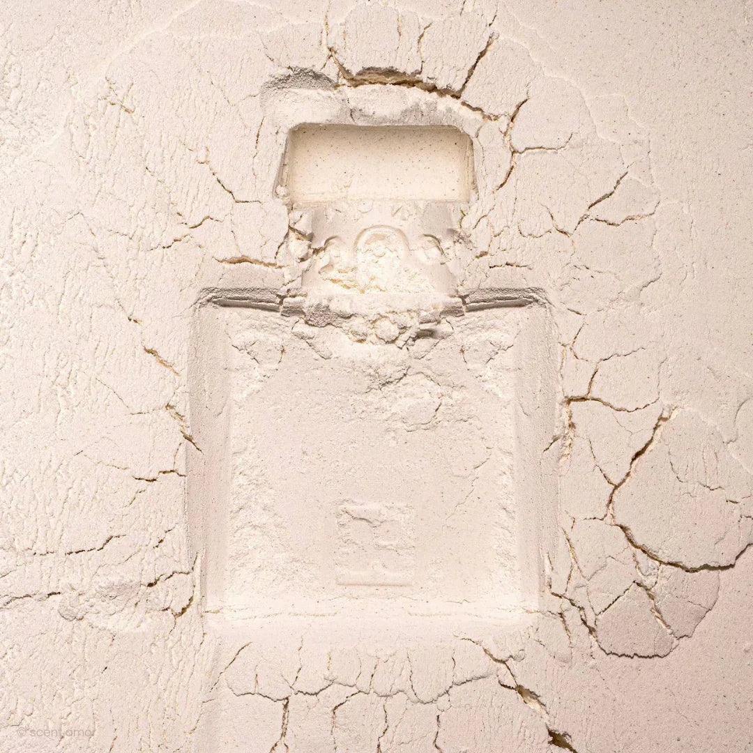 Ein Parfümflakon-Abdruck im trockenen, rissigen weißen Gips. Produkt: Sirène von FRAGRANCE DU BOIS.