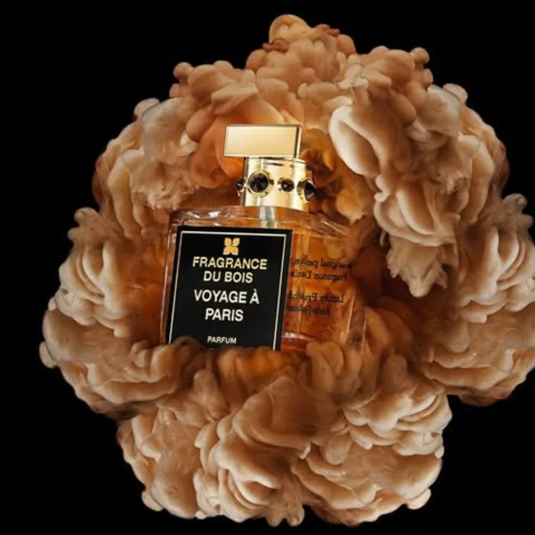 Ein Parfümflakon von "Voyage à Paris" der Marke "FRAGRANCE DU BOIS", umgeben von zarten Rauchwolken.