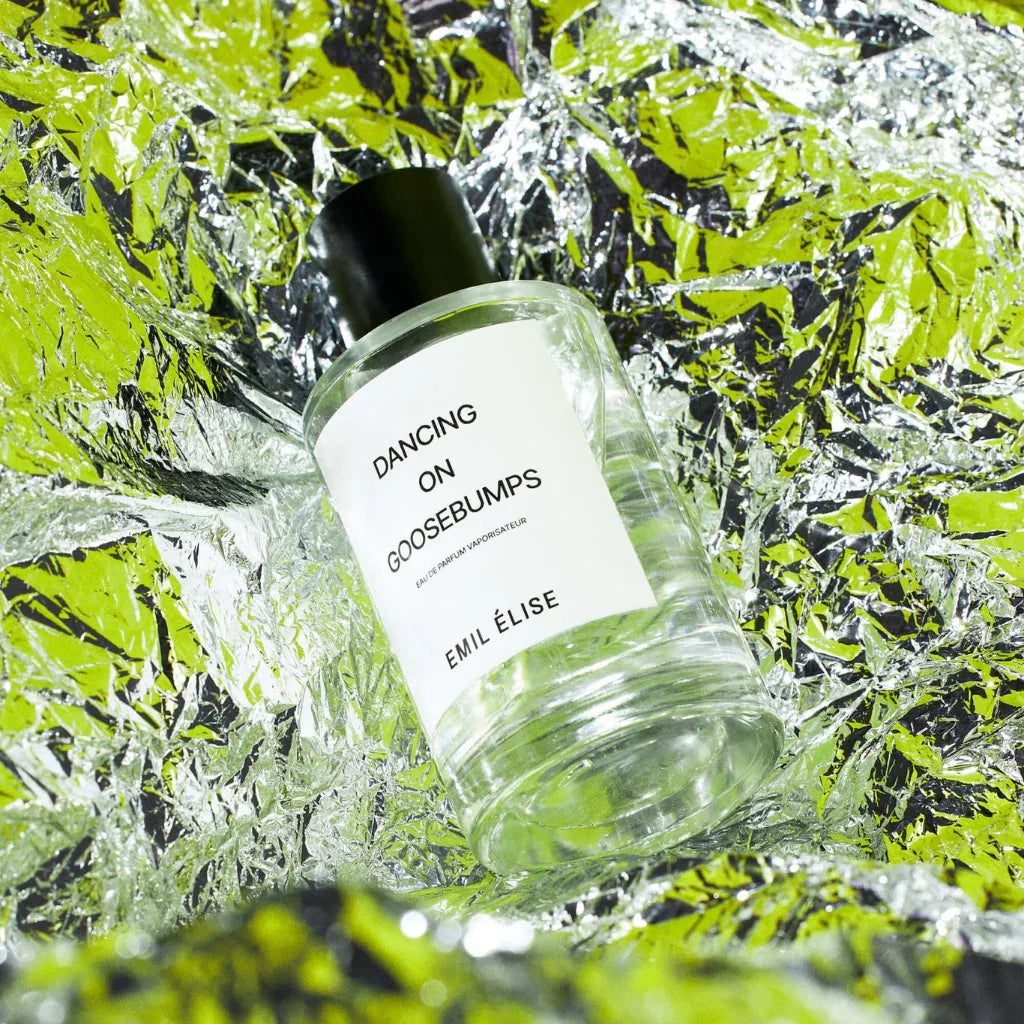 Durchsichtige Parfümflasche mit schwarzem Deckel, Etikett "Dancing on Goosebumps" von Emil Élise.