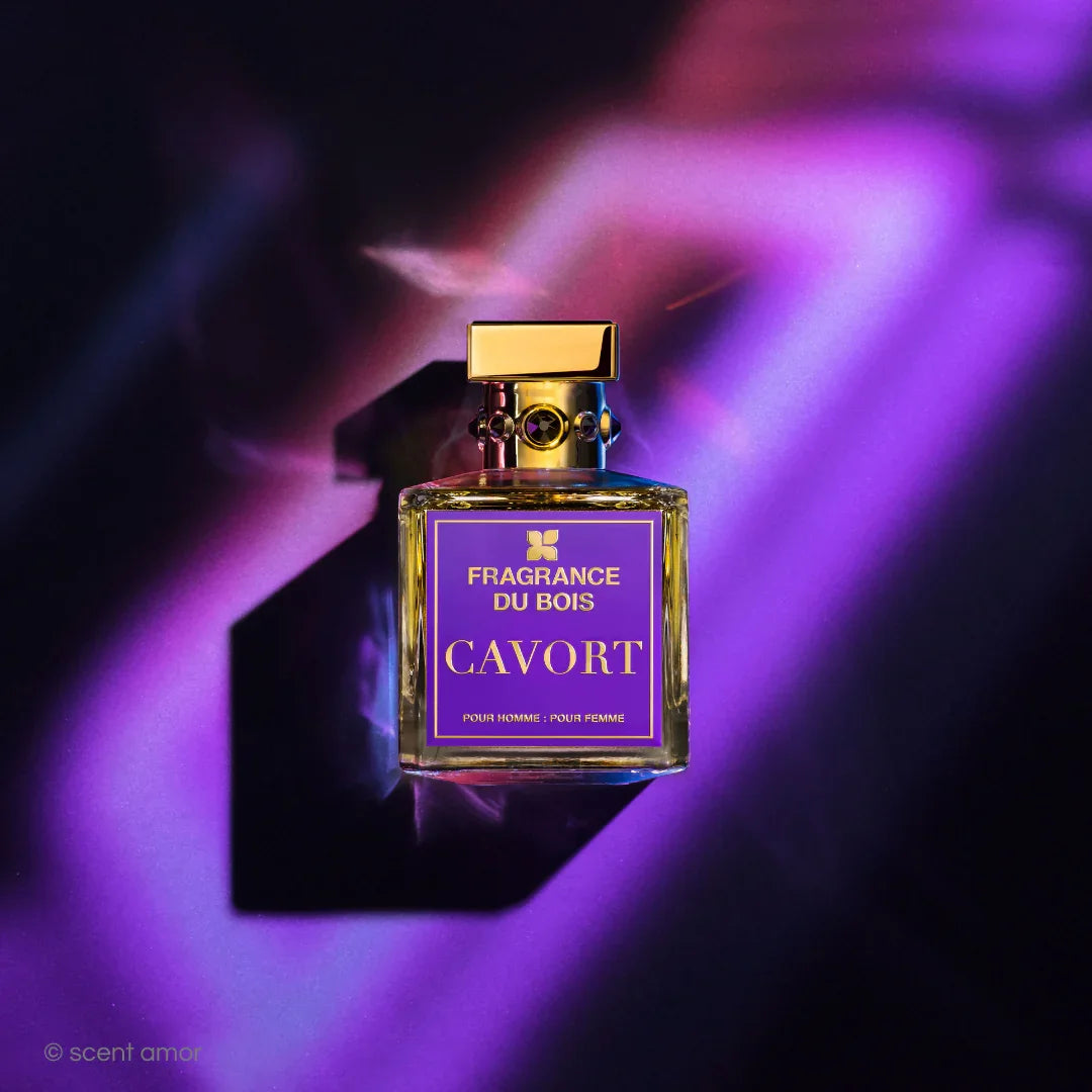 Parfümflakon "Cavort" von "FRAGRANCE DU BOIS" mit goldenem Verschluss und lila Etikett in verspieltem Licht.