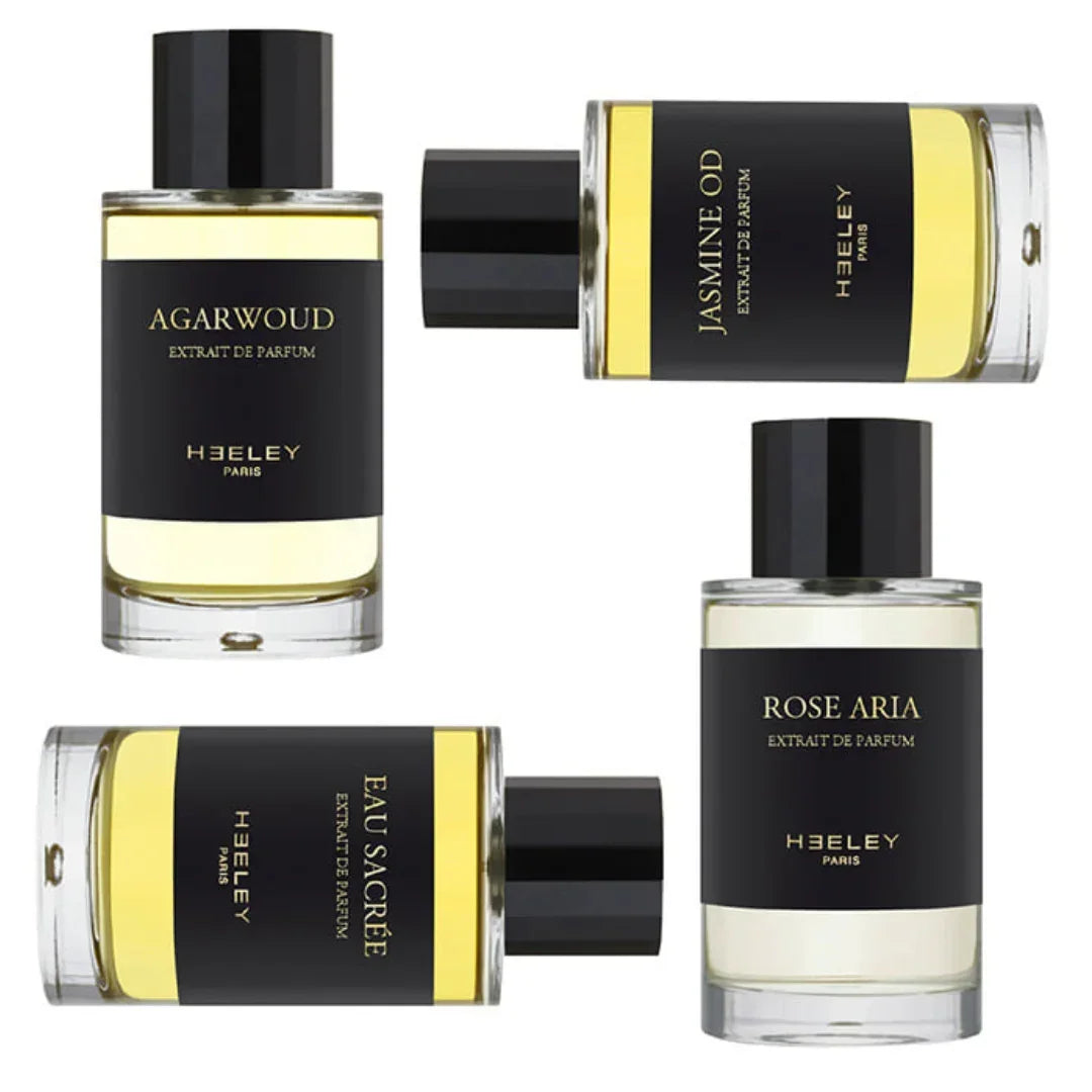 Vier Parfümflaschen von Heeley mit schwarzem Etikett: "Agarwoud", "Jasmine OD", "Rose Aria", "Eau Sacrée".