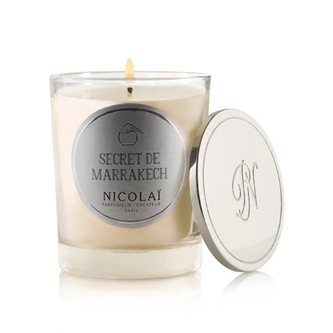 Glaskerze mit weißem Wachs, silbernem Etikett „Secret De Marrakech“, Deckel mit Initialen. Produkt: Secret De Marrakech - Duftkerze. Anbieter: Nicolaï.
