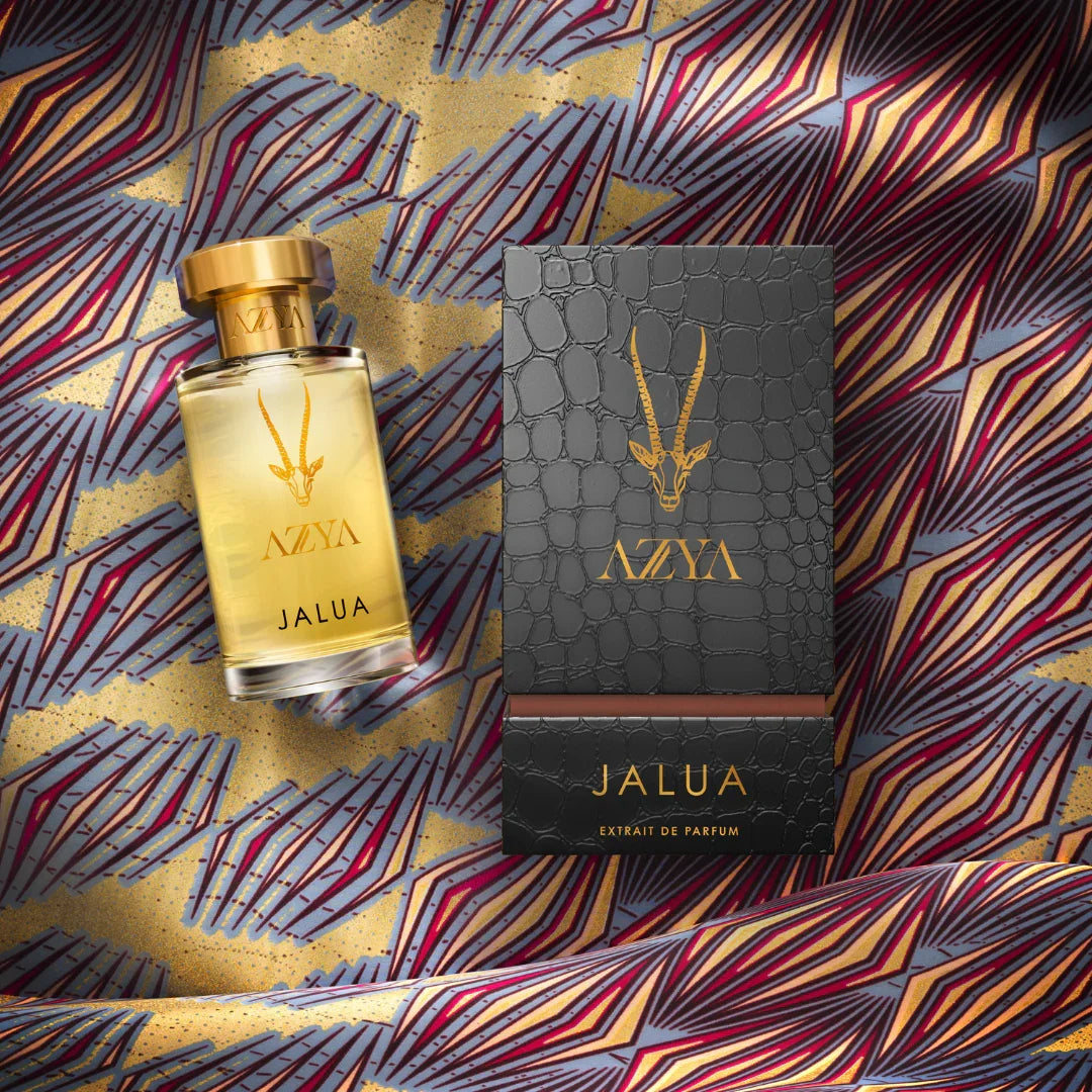 Das Bild zeigt ein Parfümflakon "Jalua" von "Azya" und eine dunkle Verpackung mit goldenen Akzenten.