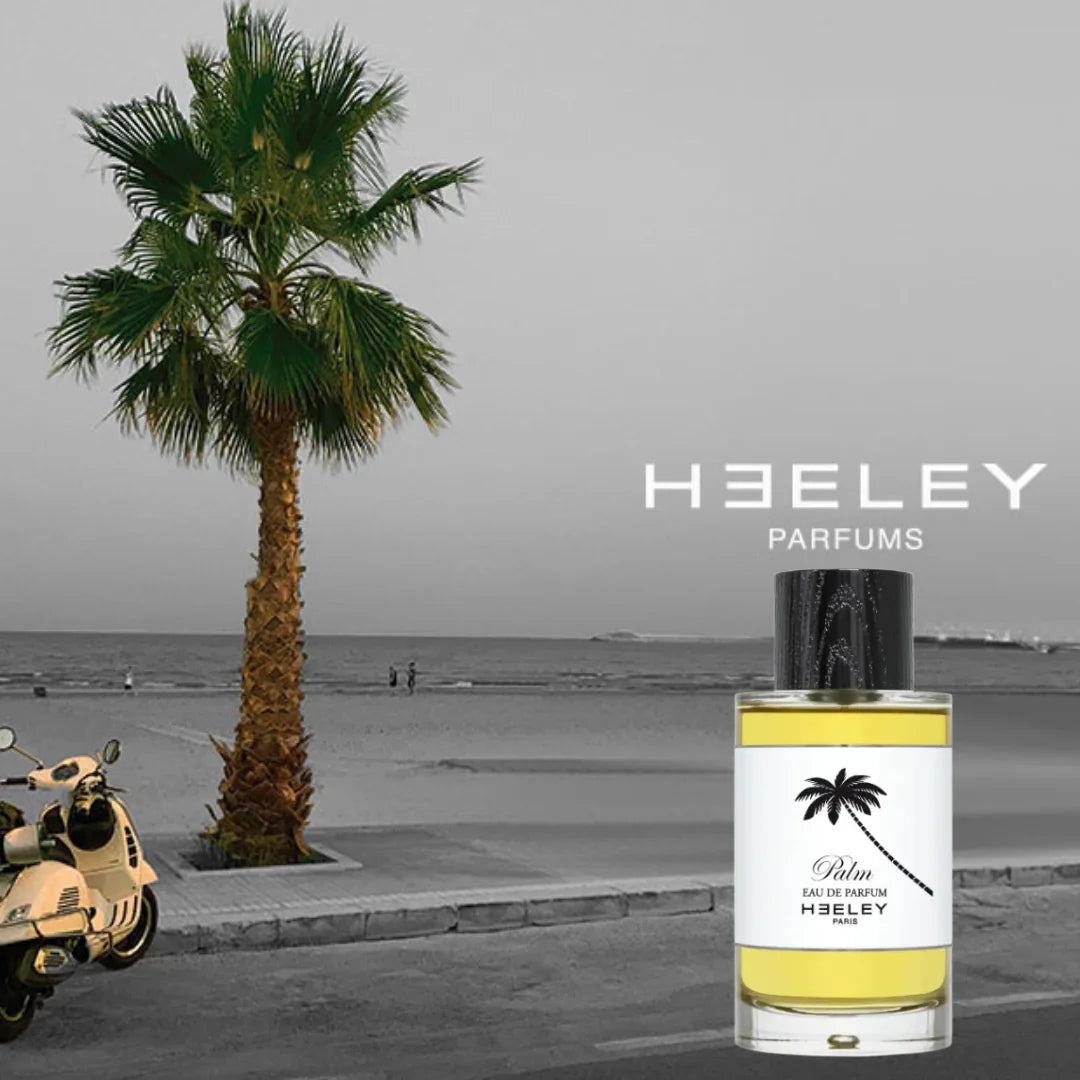 Parfümflasche "Palm" von Heeley mit gelbem Duft, schwarzem Verschluss und weißem Etikett mit Palmenmotiv.