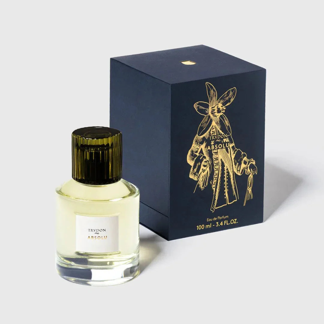 Parfümflasche und Schachtel von Trudon mit der Aufschrift "ABSOLU". Die Flasche ist durchsichtig, die Schachtel dunkelblau präsentiert von scent amor deinem Fachmann für Nischenduft