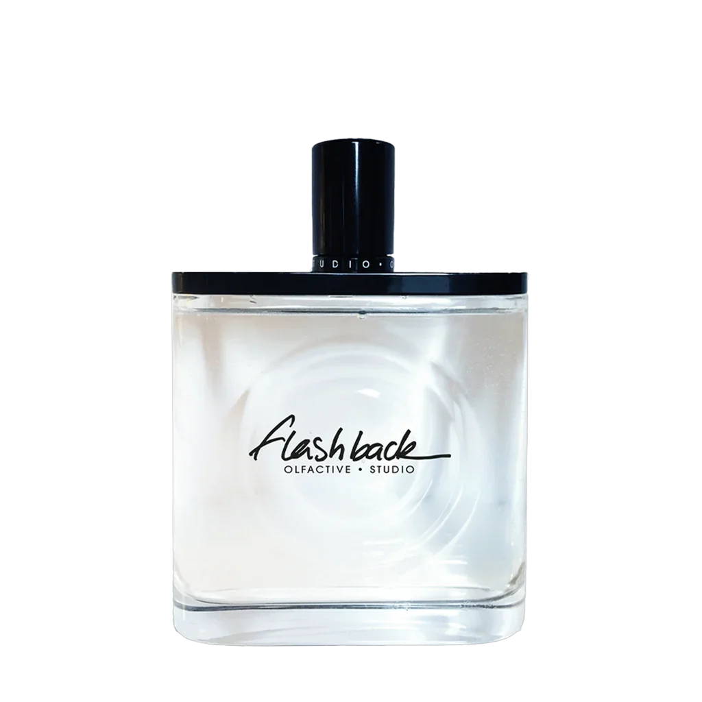 Transparente Parfümflasche mit schwarzem Verschluss, "Flash Back" und "Olfactive Studio" in schwarzer Schrift darauf.