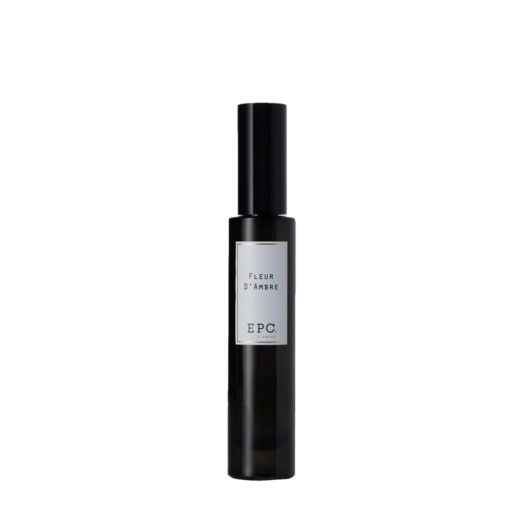 Schwarze zylindrische Parfümflasche "Fleur d'Ambre" von Experimental Perfume Club mit Etikett vorne.