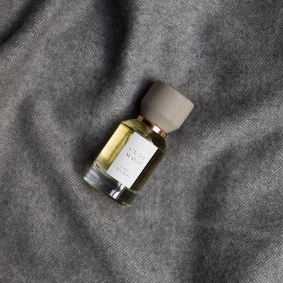 L’Eau Maliz Lazy Sunday Eau de Parfum, entspannte Komposition auf weichem Textil inszeniert, erhältlich bei scent amor.