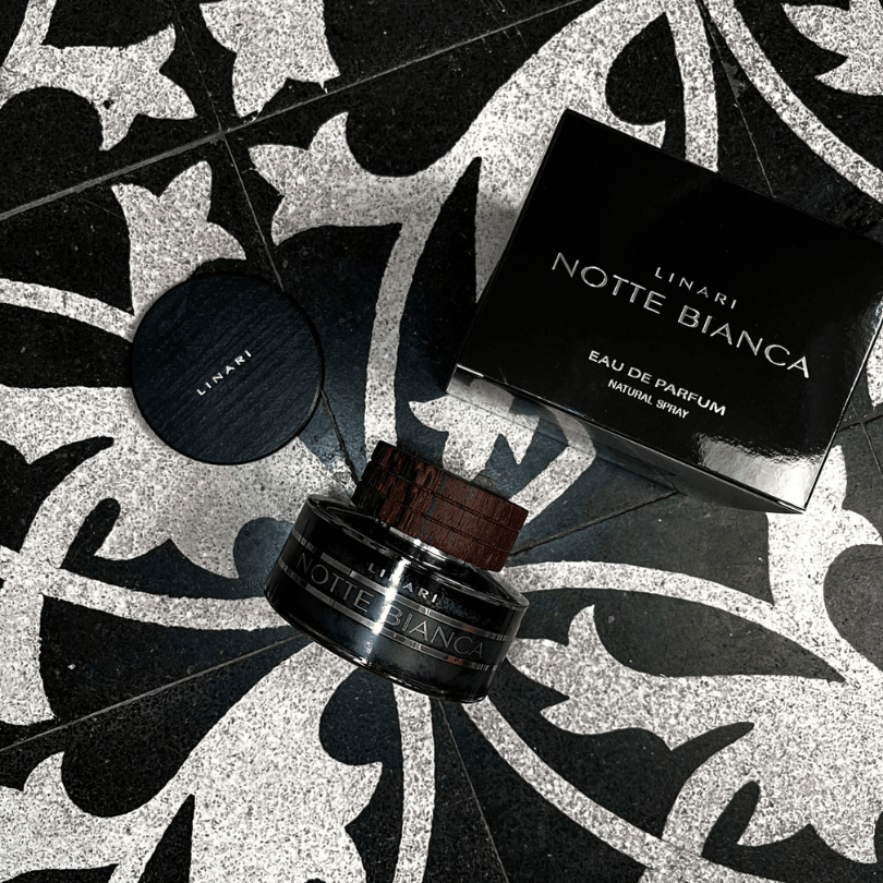 Linari Notte Bianca Eau de Parfum, edler Duftflakon mit Verpackung auf dekorativem Musterboden, kontrastreich und hochwertig inszeniert, erhältlich bei scent amor.