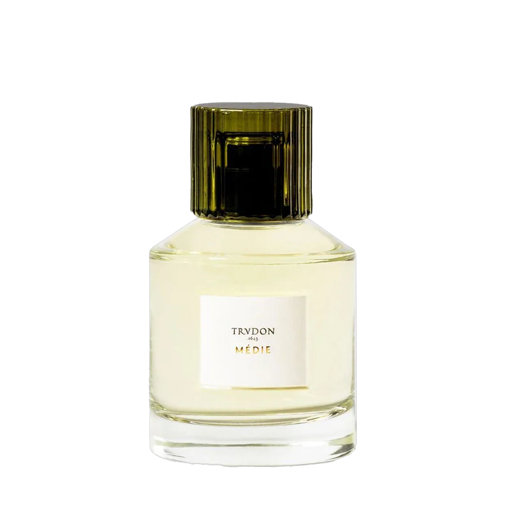 Parfümflakon von "MÉDIE" der Marke Trudon, mit zylindrischem Verschluss und transparentem Glas, das die helle Flüssigkeit zeigt.