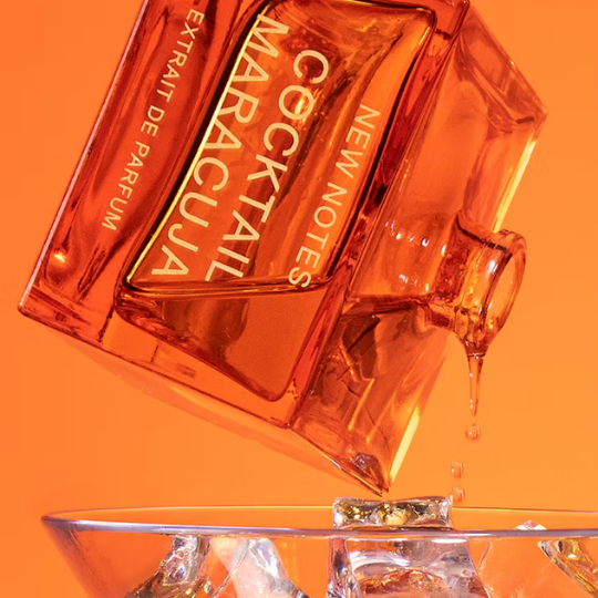 New Notes Cocktail Maracuja Extrait de Parfum, dynamische Detailaufnahme des orangefarbenen Flakons mit tropischen Cocktail-Elementen und fließender Flüssigkeit, erhältlich bei scent amor.