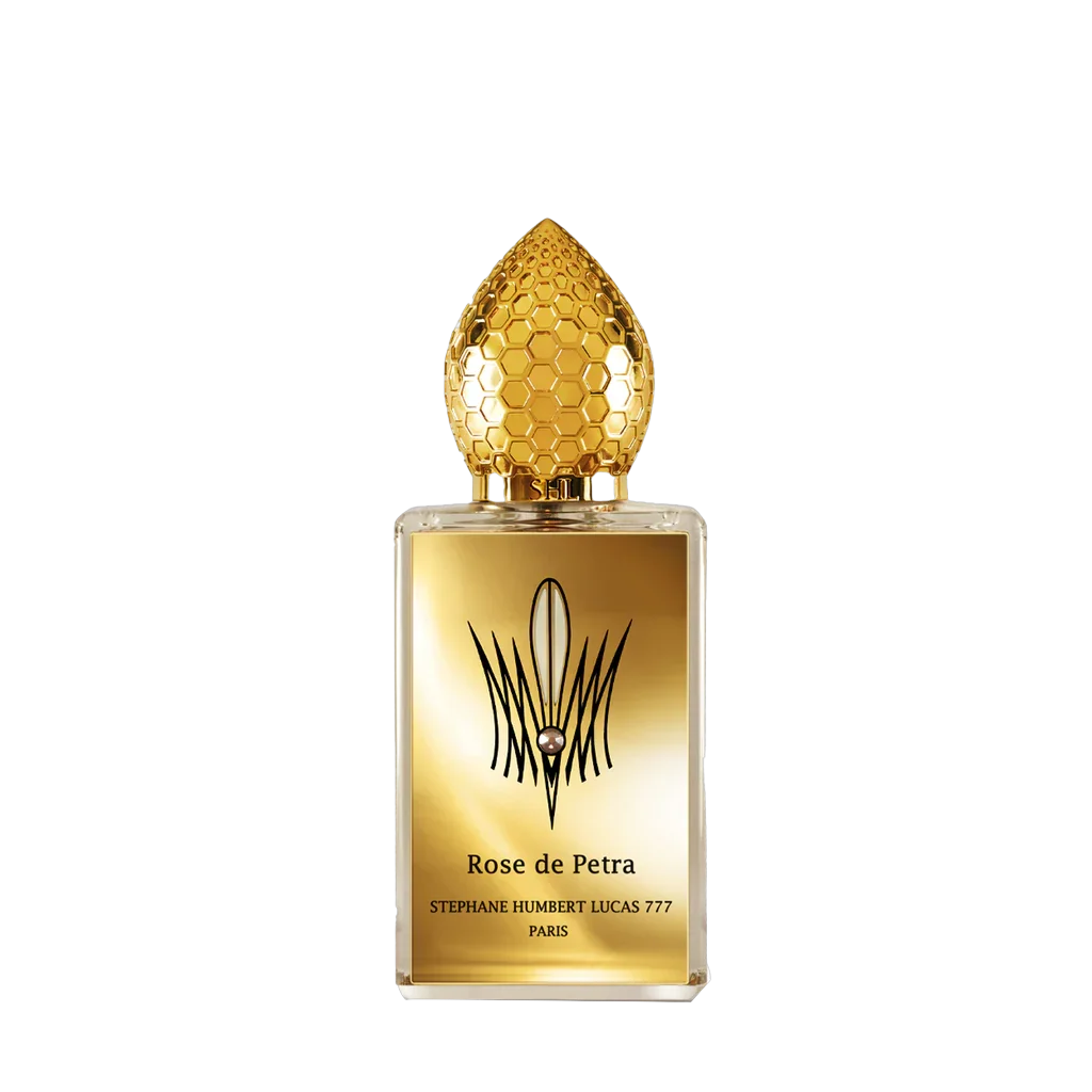 Klares, rechteckiges Parfümfläschchen "Rose de Petra" von Stéphane Humbert Lucas, mit goldener, bienenwabenstrukturierter Kappe.