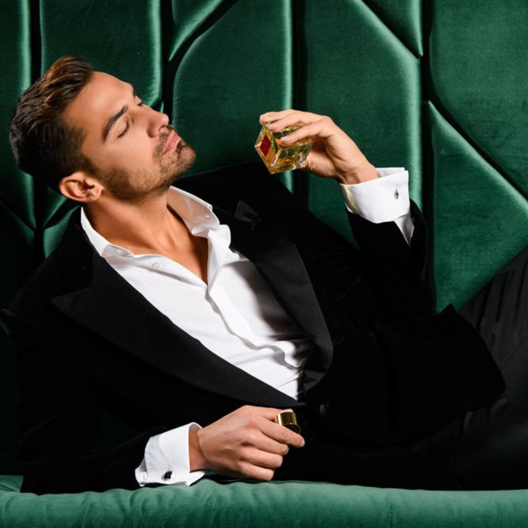 Quintessence Eau de Parfum von Manos Gerakinis bei scent amor - Flakon in der Hand eines Mannes auf edler Samtcouch