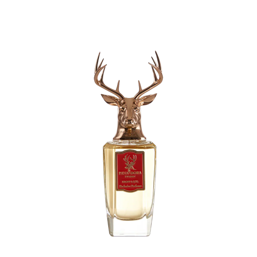 Goldene Parfümflasche "Kropp & Själ" von Pana Dora mit Hirschkopf-Verschluss und rotem Etikett auf der Vorderseite.
